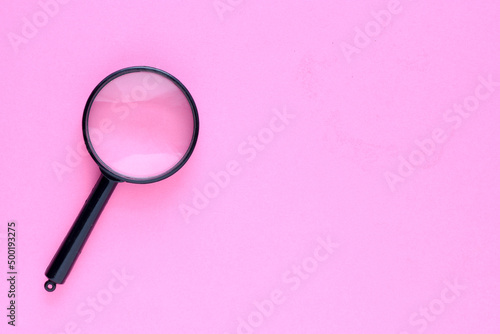 Wallpaper Mural Black magnifier on a pink background. Torontodigital.ca