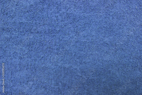 Texture of a blue terry towel close-up. Cotton fabric.