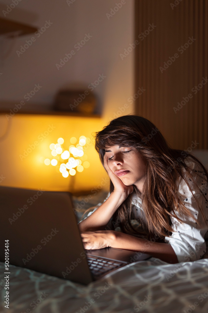 Woman tired while working late at night Woman tired while working late at night