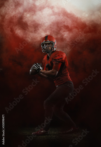 Red sky. Creative portrait of young man, american football player at stadium in motion on smoked background. Sport, challenge, goals, activity, sportlife concept.