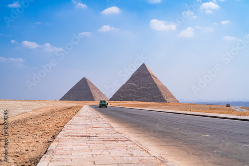 The impressive pyramids of Cheops and Kefren with the city of Cairo in the background at the foot of the road. Photograph taken in Giza, Cairo, Egypt. photo