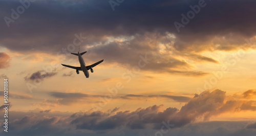 Aircraft flyingon a sunset background © Sergey Fedoskin