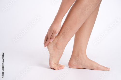 Pain in woman s legs on white background  studio shot