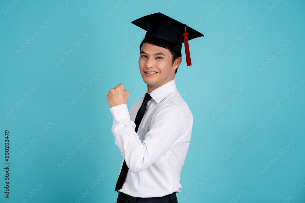 Young asian nerd man wearing wearing a school uniform and graduation cap smiling looking confident at the camera Young asian nerd man wearing wearing a school uniform and graduation cap smiling looking confident at the camera
