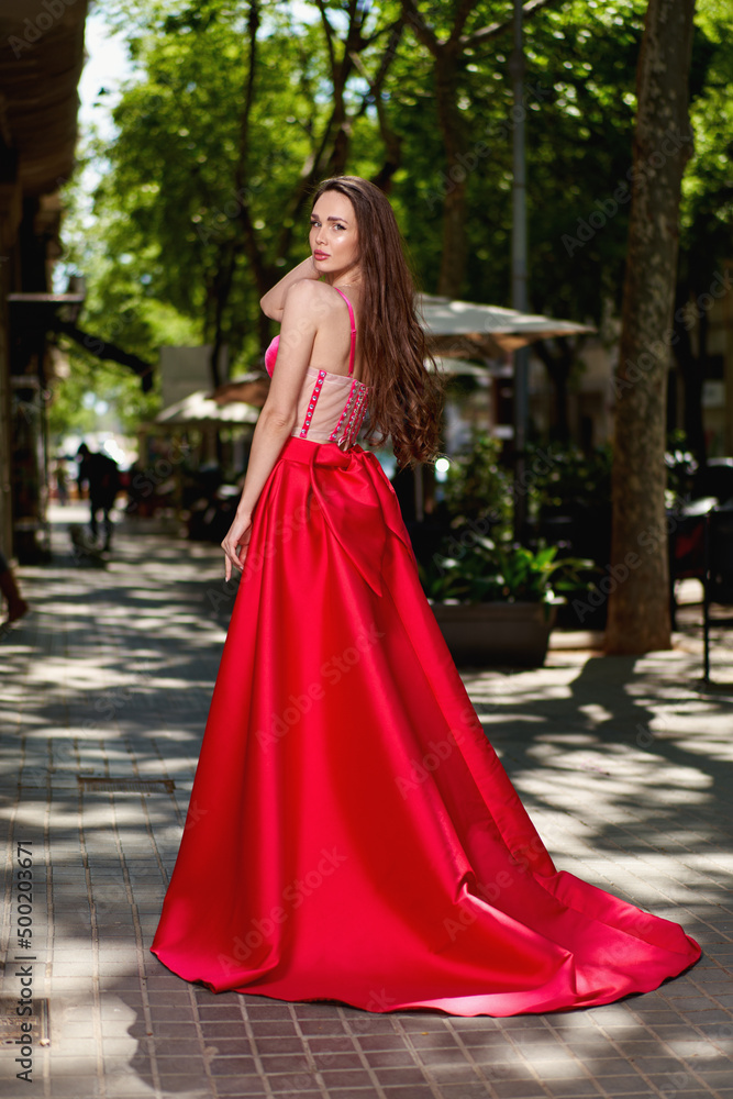 beautiful girl in a red dress on the street
