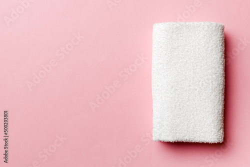 Top view of white towels with copy space on colored background photo