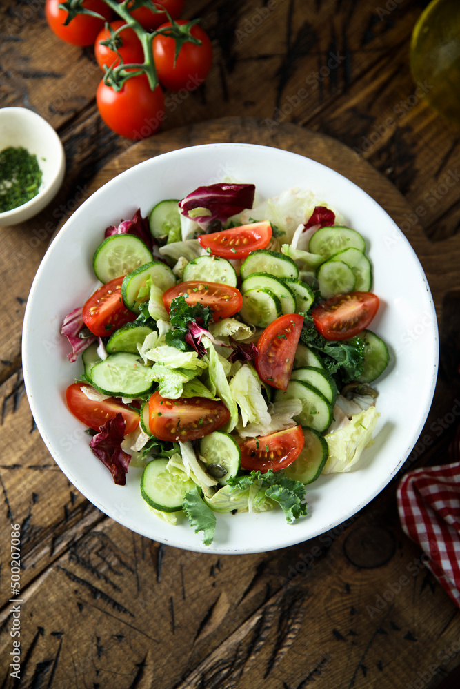Healthy green salad with tomato and cucumber Healthy green salad with tomato and cucumber