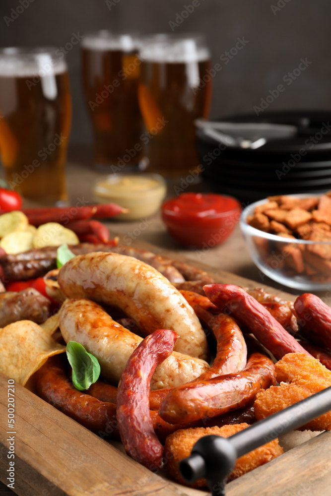 Set of different tasty snacks and beer on wooden table, closeup view Set of different tasty snacks and beer on wooden table, closeup view
