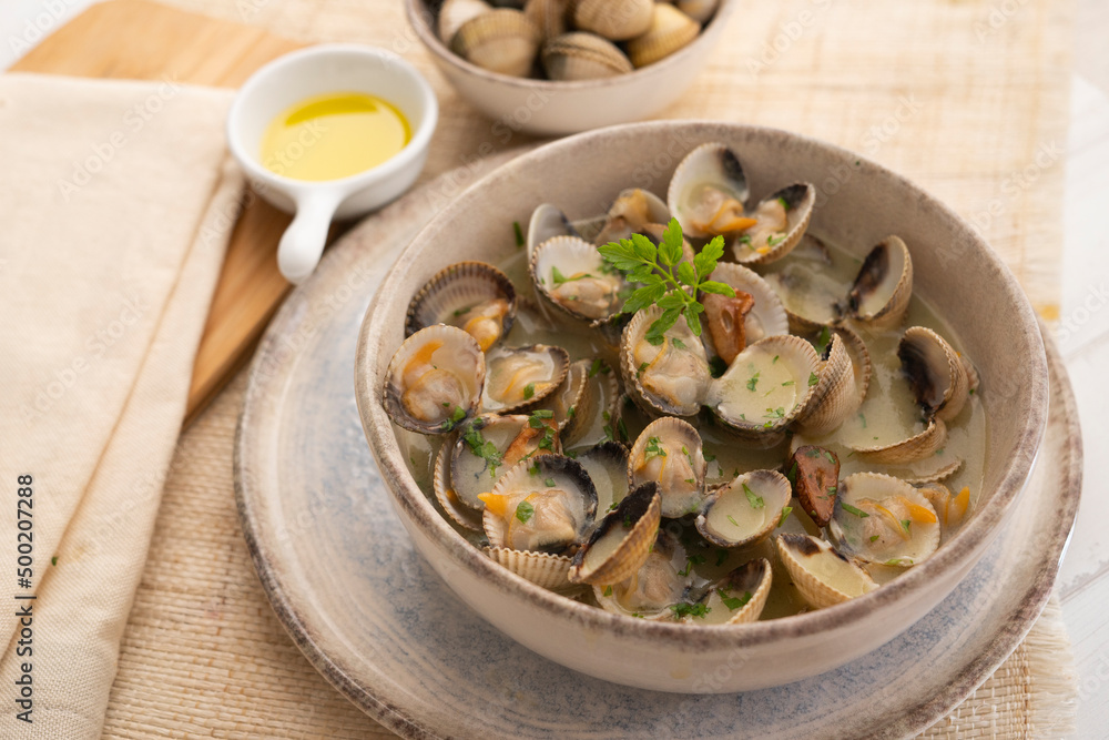 Cockles cooked in green sauce. Traditional Basque country recipe. Spanish cover. Cockles cooked in green sauce. Traditional Basque country recipe. Spanish cover.