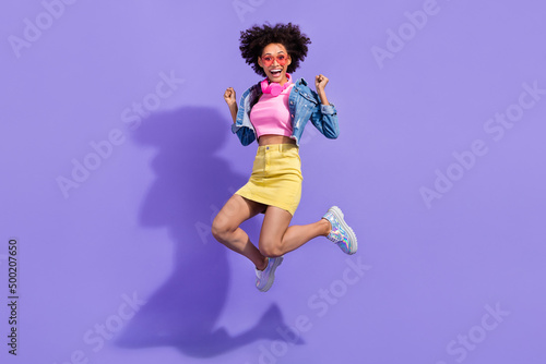 Full length body size view of attractive cheery lucky girl jumping holiday rest isolated on bright violet purple color background