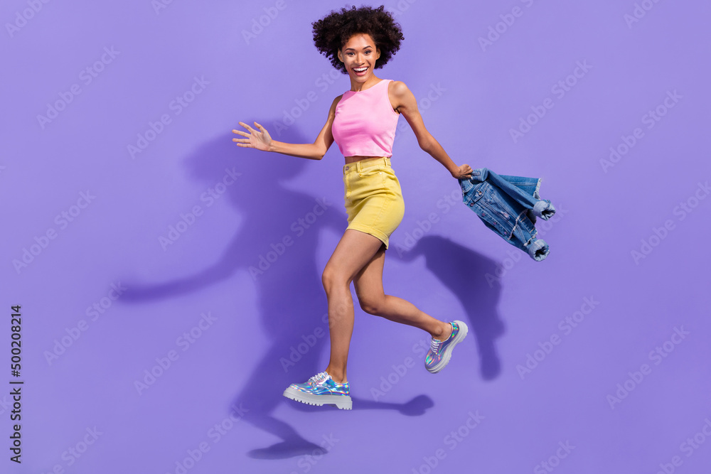 Full length body size view of attractive cheerful thin girl jumping going motion isolated on bright violet purple color background