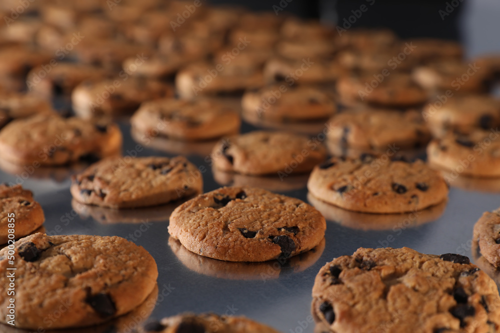 Many delicious cookies on production line, closeup Many delicious cookies on production line, closeup