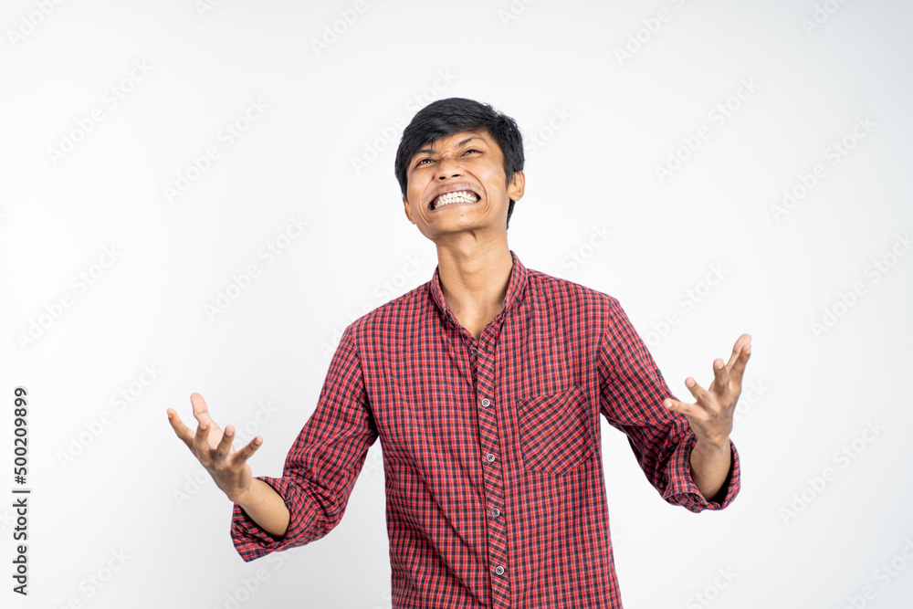 Stressed asian young man scream on isolated on white background Stressed asian young man scream on isolated on white background