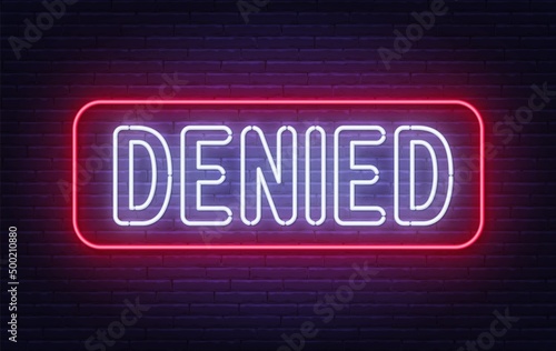 Denied neon sign on brick wall background