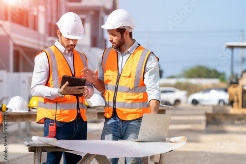Obraz na płótnie Engineer and architect discussing building plan at construction site,Group of builders having conversation about building plan,business,building,industry,people concept
