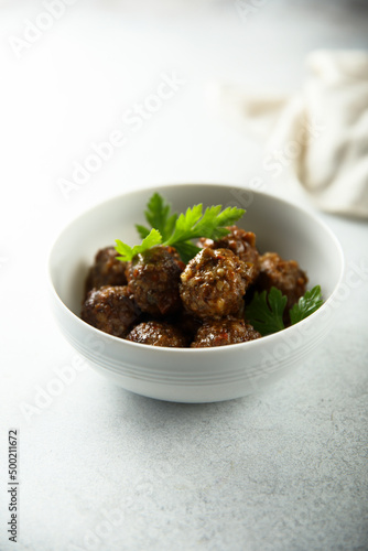 Homemade meatballs in a white bowl