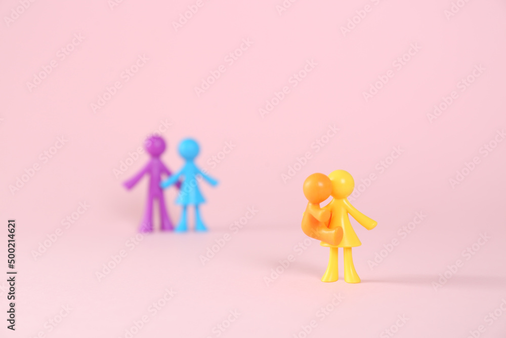 MYKOLAIV, UKRAINE - JANUARY 04, 2022: Colorful human figures on pink background. Surrogacy concept MYKOLAIV, UKRAINE - JANUARY 04, 2022: Colorful human figures on pink background. Surrogacy concept