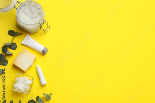 Flat lay composition with beeswax cosmetics on yellow background. Space for text