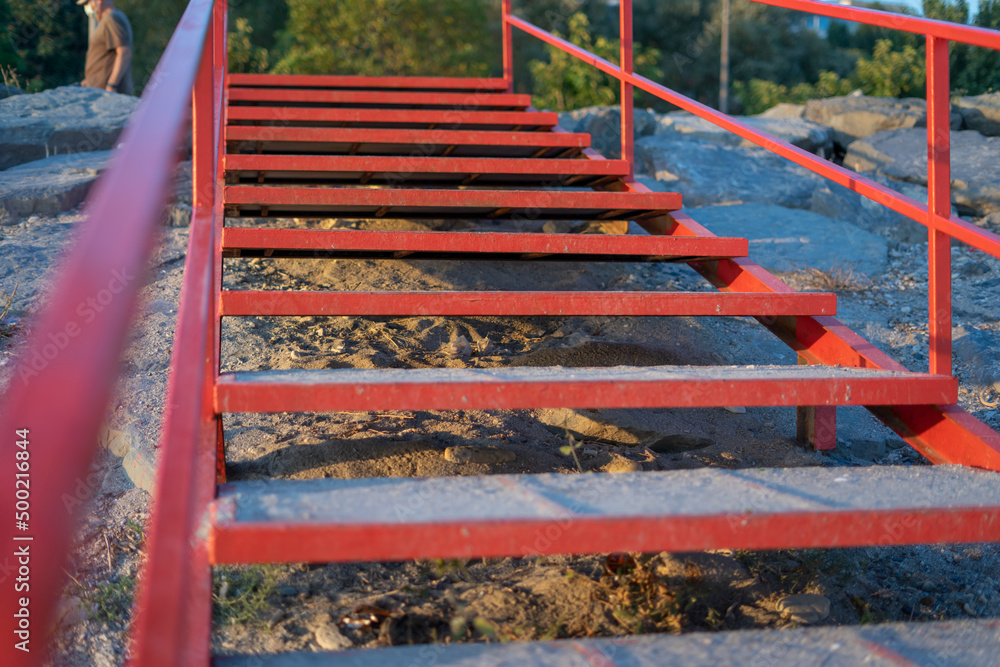 Beach stairs with red metal railing