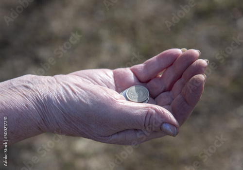 Russian coins in the hands of an elderly woman.