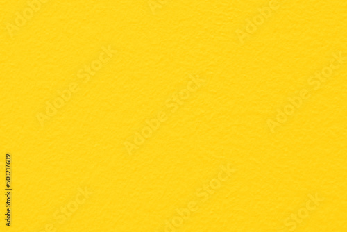 Yellow concrete wall texture background. Yellow paint colour cement background. 