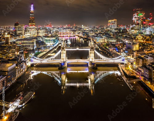 Drone shot of Tower Bridge and the City of London at night