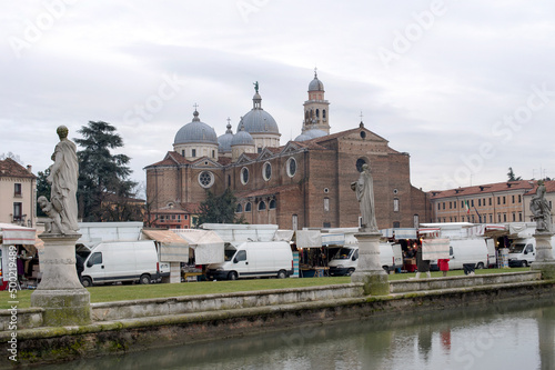 Part of the park with the canal with its 78 statues and the Abbey of Santa Giustina in the Prato della Valle square, Padua, Italy. photo