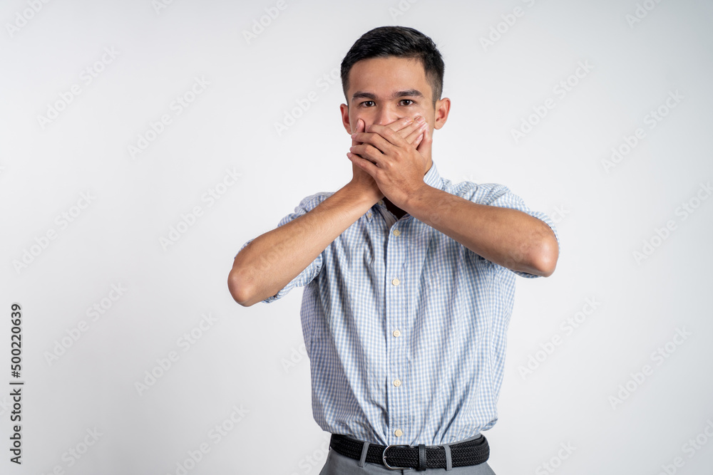 portrait of asian young man cover his nose and feeling disgusted by the smell portrait of asian young man cover his nose and feeling disgusted by the smell