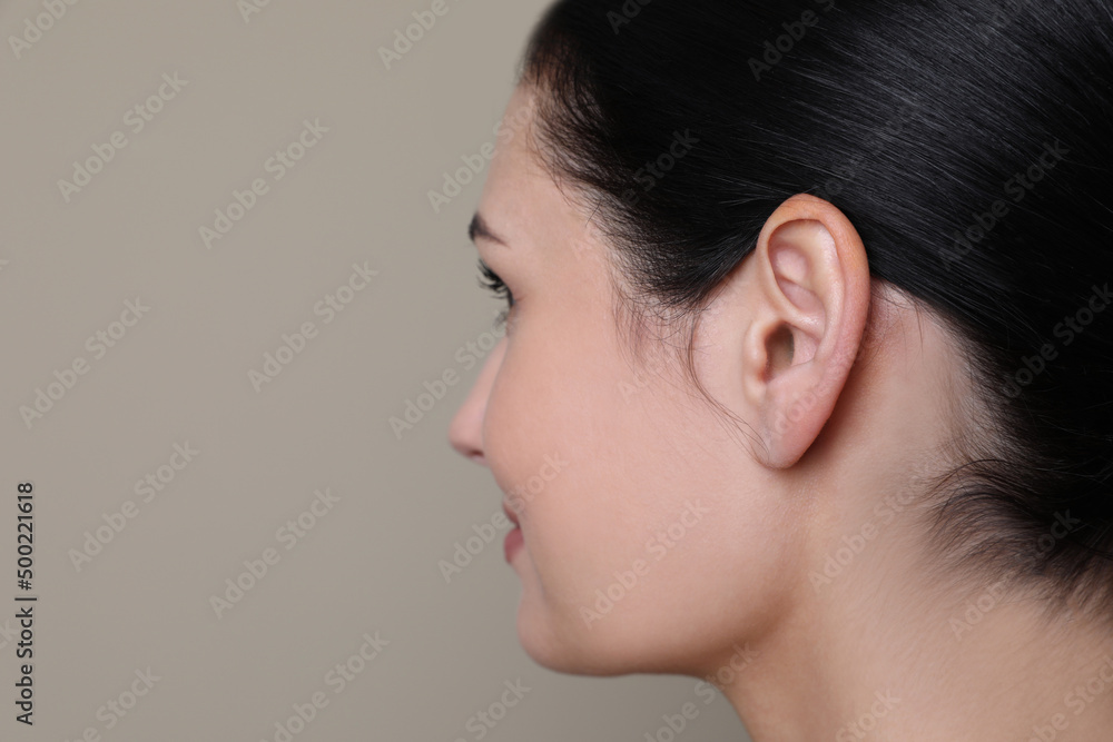 Young woman on grey background, closeup. Space for text Young woman on grey background, closeup. Space for text