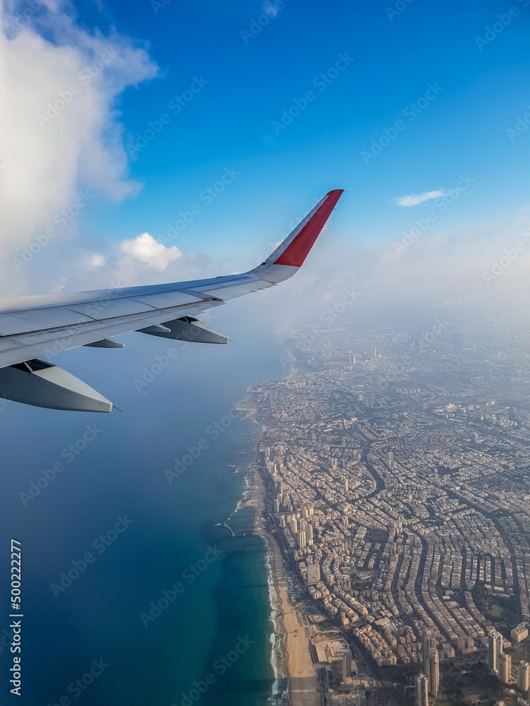 Fototapeta premium Aerial view of Tel Aviv skyline from a plane taking off from Ben Gurion airport .