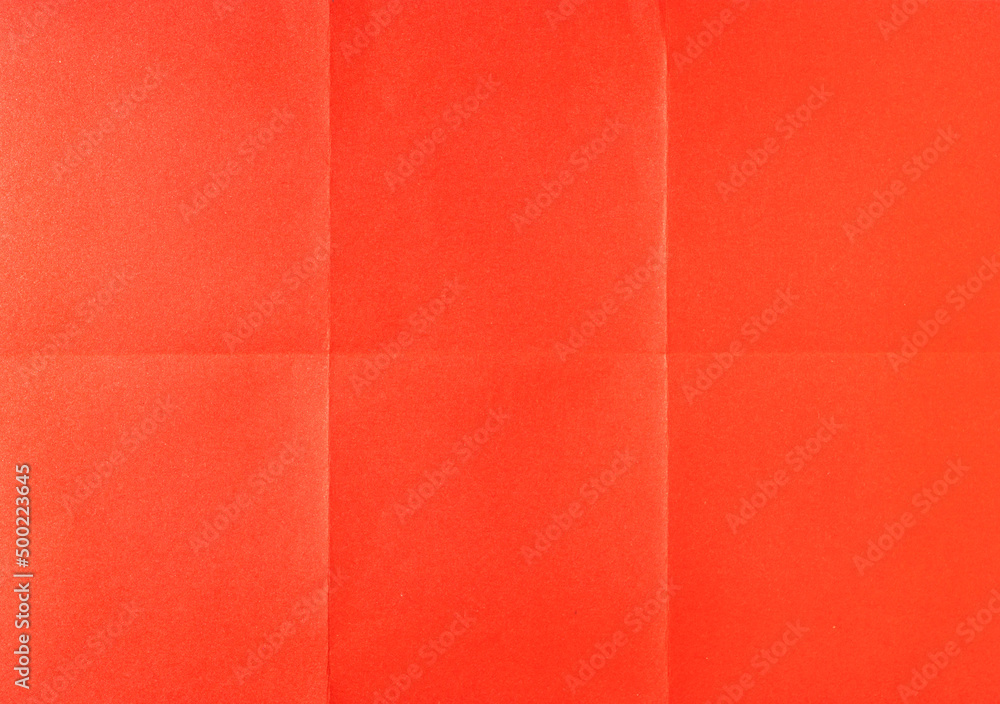 Fototapeta premium Red crumpled unfolded paper sheet texture background. Paper folded in six. Full frame