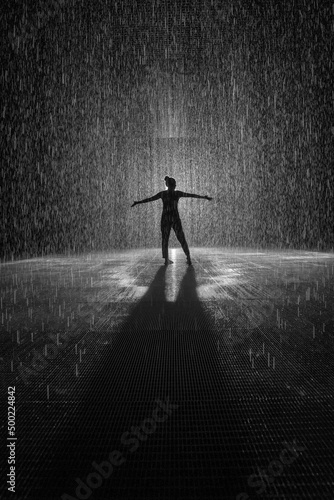 Rain Room Silhouette of person dancing in rain.