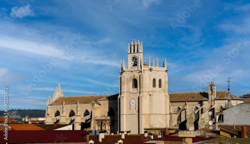 Panoramic view of the Gothic Cathedral of Palencia, 14th century, with blue sky and light white clouds.