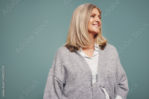 Blonde-haired mature woman smiling in a studio photo