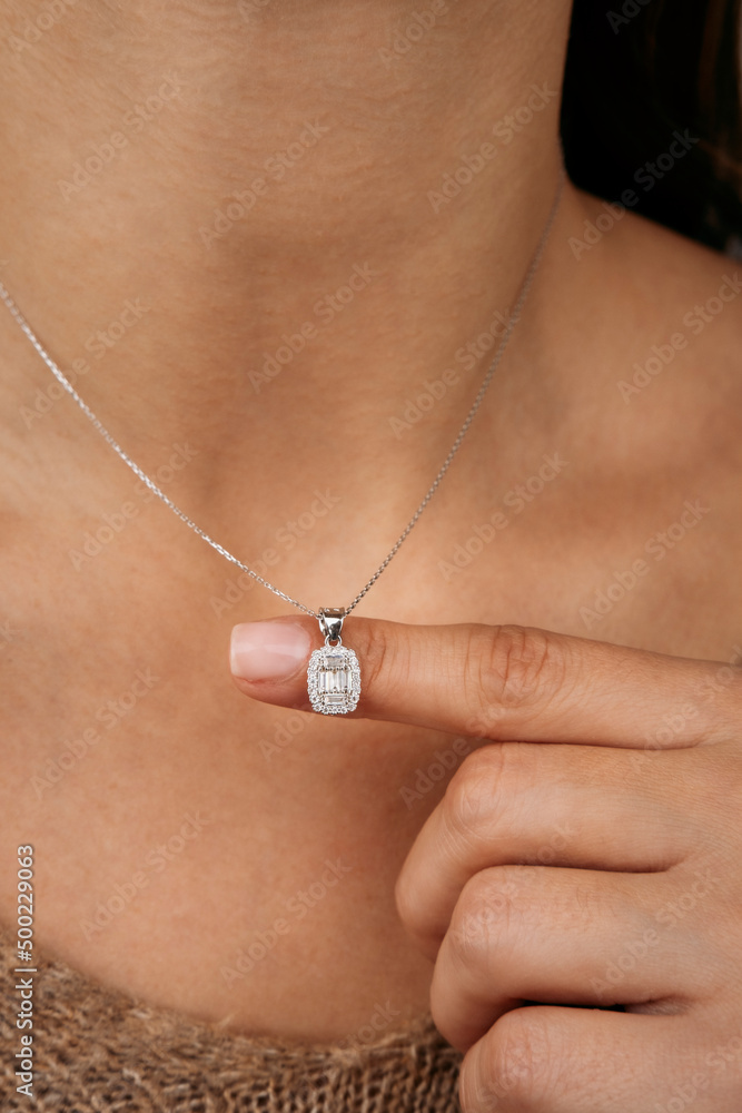 Close-up young woman wearing gold chain necklace. Modern fashion details. minimalist lifestyle Close-up young woman wearing gold chain necklace. Modern fashion details. minimalist lifestyle