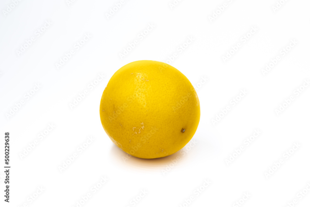 One whole citrus fruit a hybrid of orange and lemon in light orange color on a white background isolated One whole citrus fruit a hybrid of orange and lemon in light orange color on a white background isolated