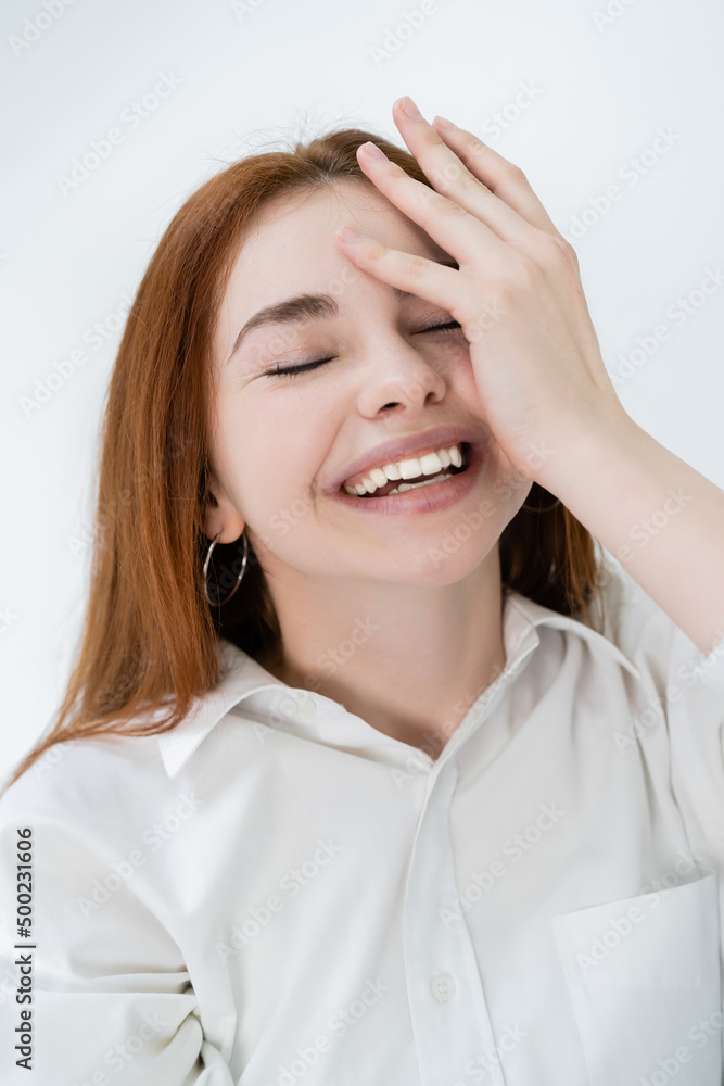 Portrait of redhead woman laughing with closed eyes isolated on white. Portrait of redhead woman laughing with closed eyes isolated on white.