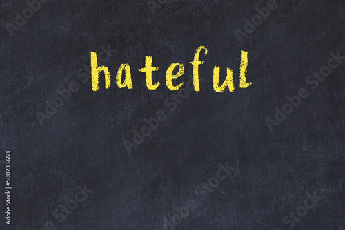 Fotografie, Obraz College chalk desk with the word hateful written on in