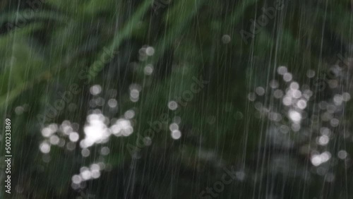 footage of defocused Rain water pouring down due to cyclonic storm and strong wind with blur Nature background