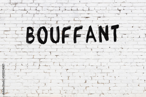 Inscription bouffant painted on white brick wall photo