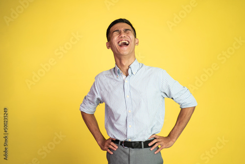 portrait of asian businessman laughing naturally over isolated background © Odua Images