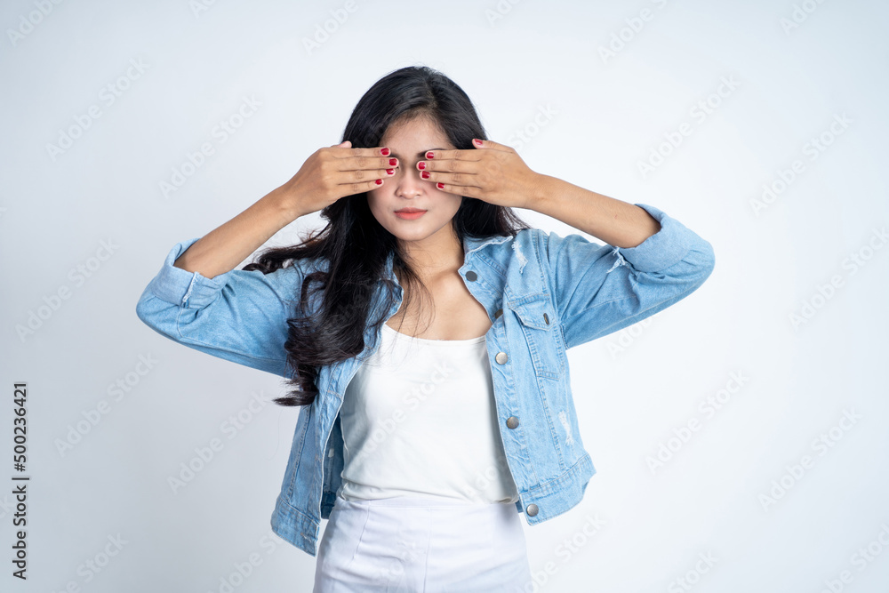 Asian woman closing eyes with both palms on isolated background Asian woman closing eyes with both palms on isolated background