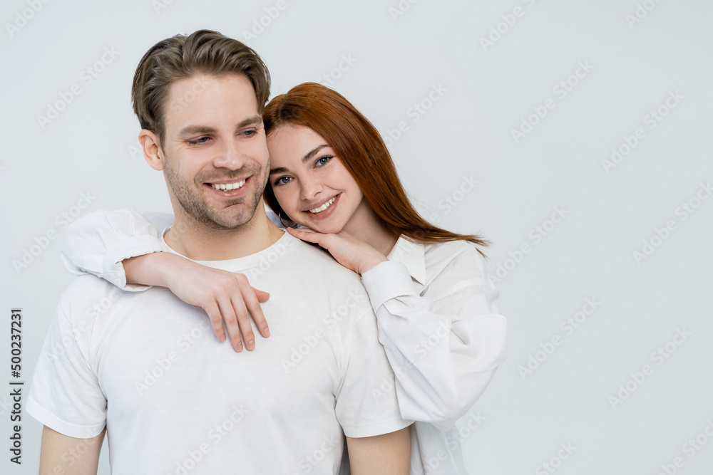 Positive young woman embracing boyfriend isolated on white. Positive young woman embracing boyfriend isolated on white.