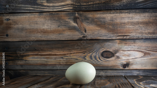 Araucana egg on wooden background. Light blue egg from Araucana chicken. Easter Festival concepts. Easter egg.