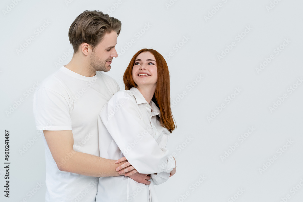 Cheerful woman looking at boyfriend isolated on white. Cheerful woman looking at boyfriend isolated on white.
