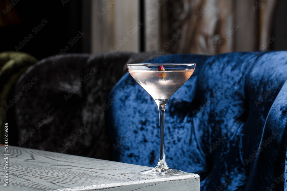 Summer refreshment drinks. Light pink rose cocktail, with rose wine on dark background. With rose flowers. Copy space