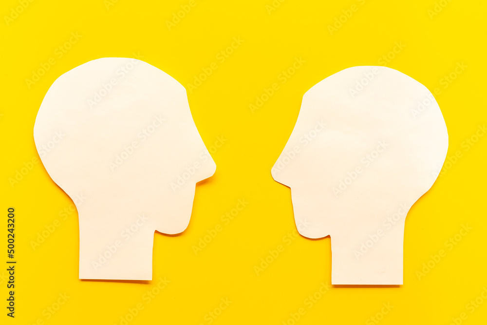 Social communication and connection concept with two paper human heads