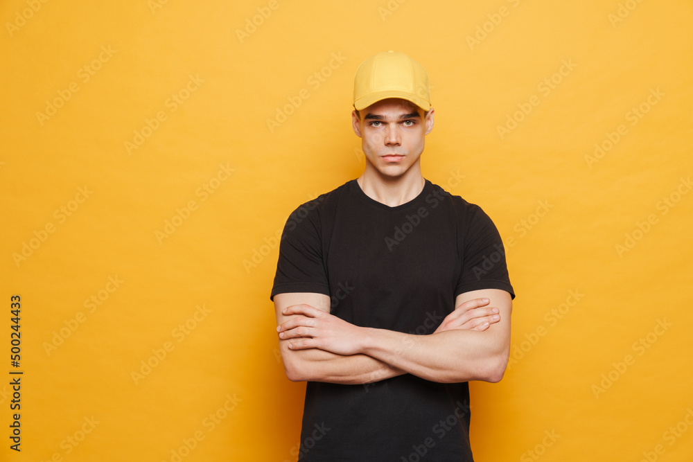Young white man wearing cap posing and looking at camera