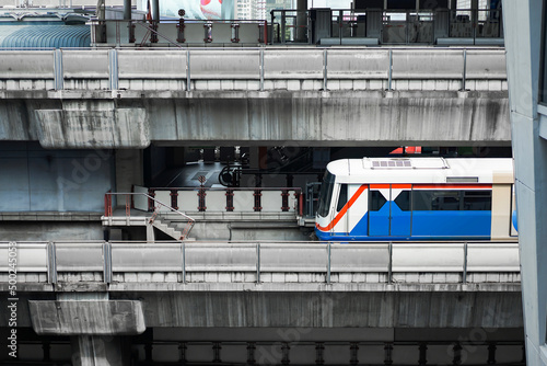 Bangkok Mass Transit System (BTS) in close up section view is driven across the Siam Square Station from Siam Square One Building view. Bangkok, Thailand. photo