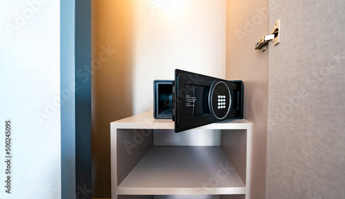 Opened Unlock digital modern Black Safe box, Stroungbox on the shelf in wood Closet in Hotel room
